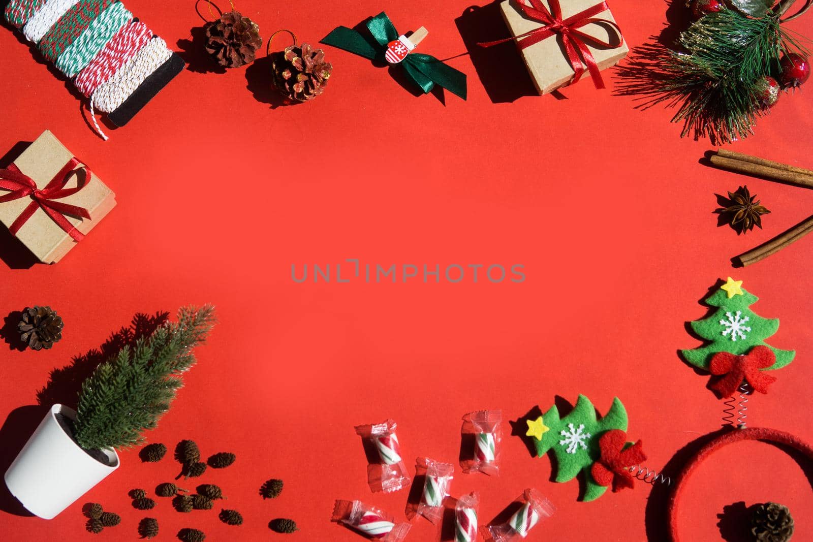 Christmas background with Xmas gifts and candy canes on red. flat lay. Space for text