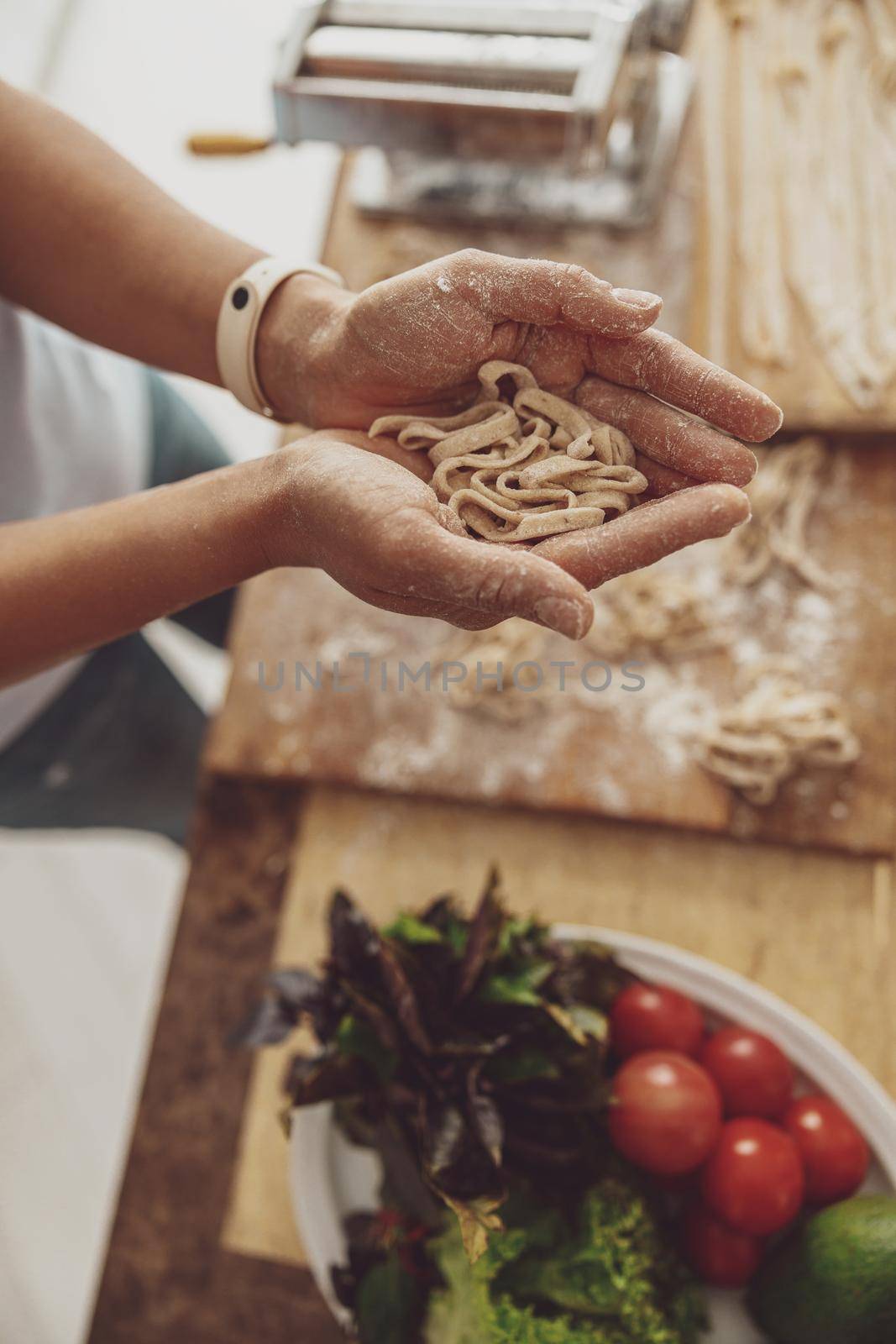 Homemade noodles cooked by a woman in her kitchen from quality flour