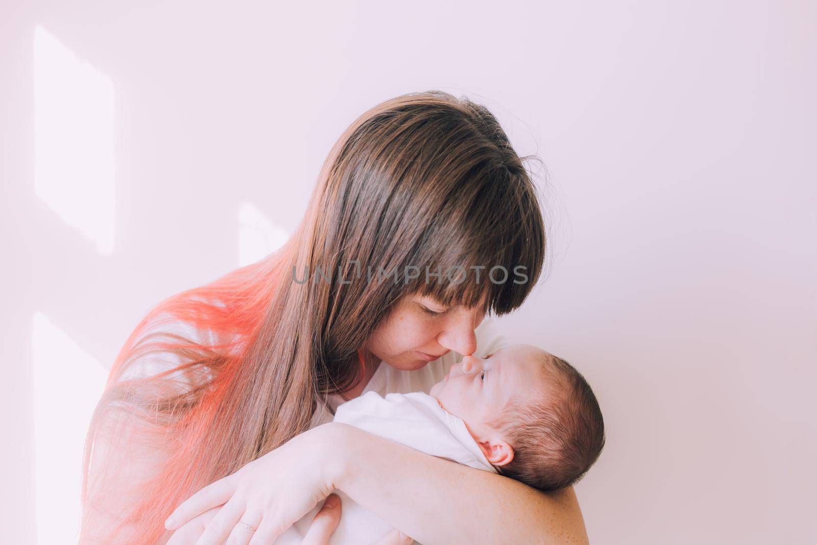 Mom holds the baby in her arms lifestyle . Mother's love for her son. A newborn baby. Mother and child relationship.