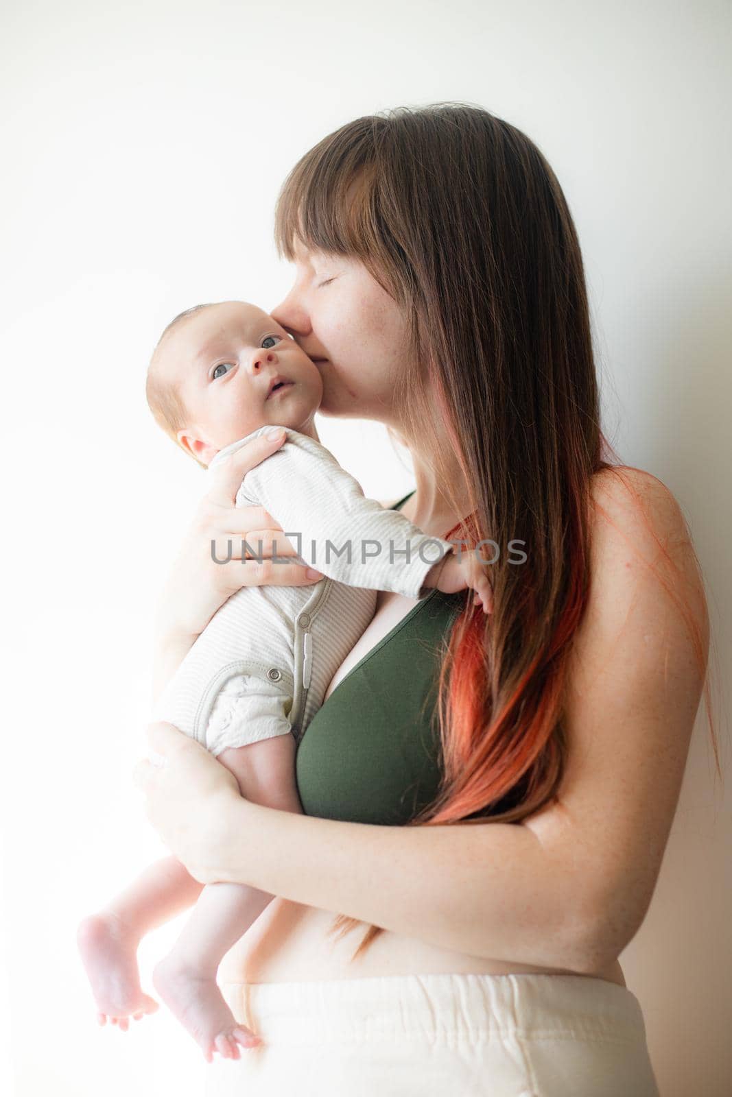 Mom holds the baby in her arms lifestyle . Mother's love for her son. A newborn baby. by alenka2194