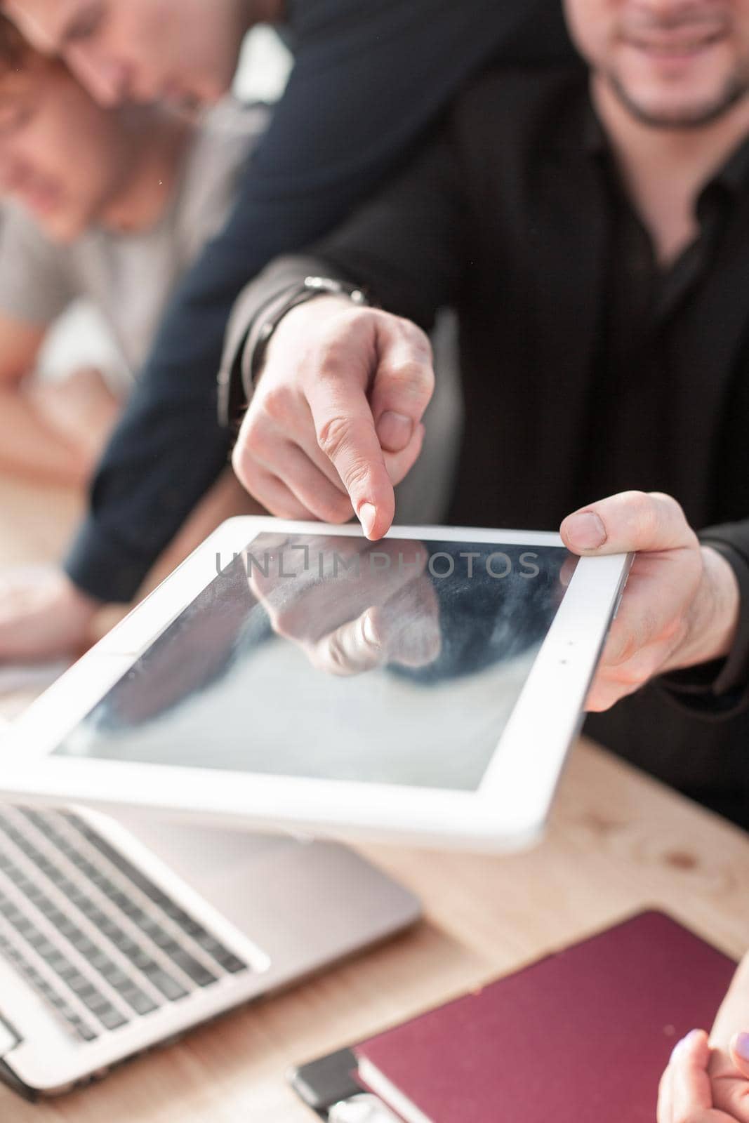 hand using digital tablet finger touch blank screen on desk work by asdf