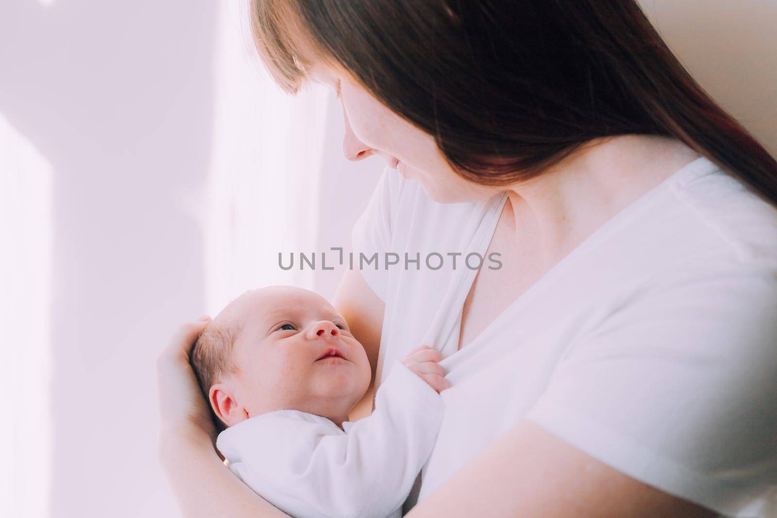 Mom holds the baby in her arms lifestyle . Mother's love for her son. A newborn baby. by alenka2194