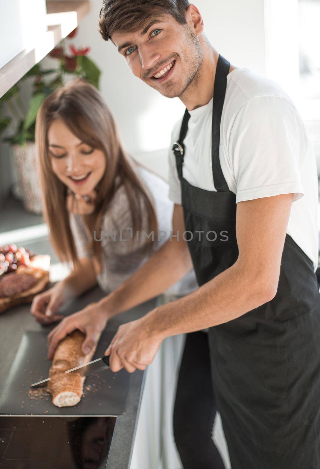 happy young couple standing in their new kitchen by asdf