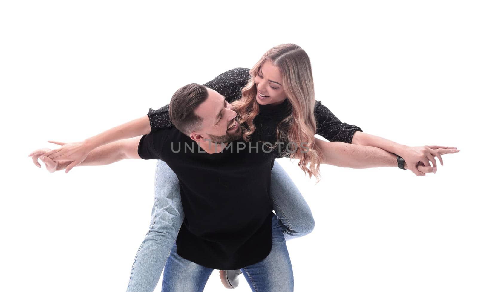 in full growth. a young couple in love is having fun . isolated on white background