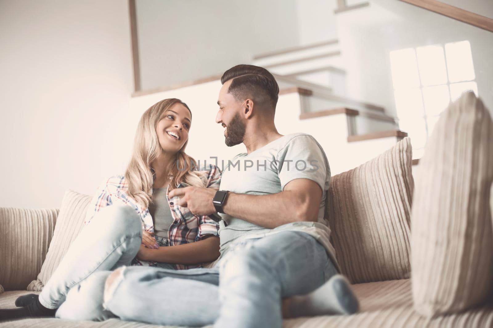 loving couple sitting on sofa in cozy living room by asdf