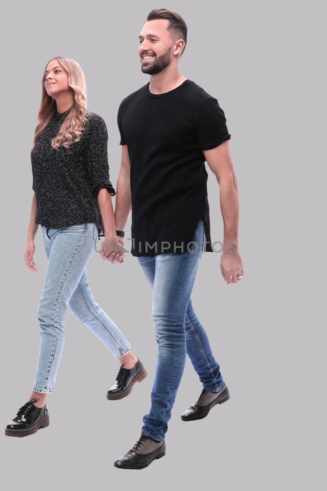 in full growth. young couple walking together by asdf