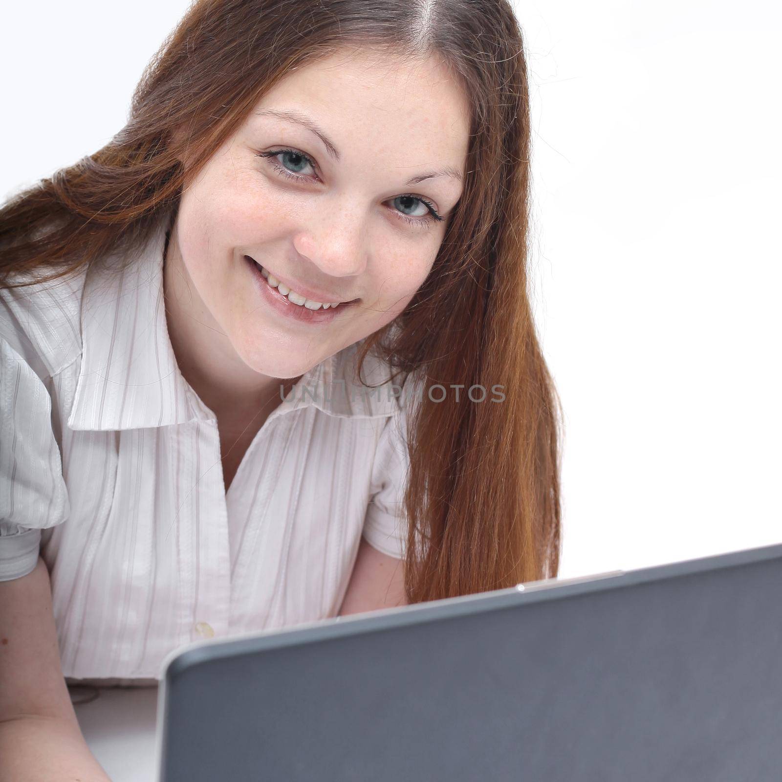 young modern girl with laptop lying on the floor. isolated on white .photo with copy space.