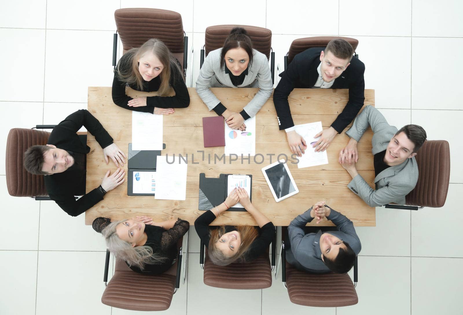 top view. young business team sitting at a table and looking at the camera by asdf