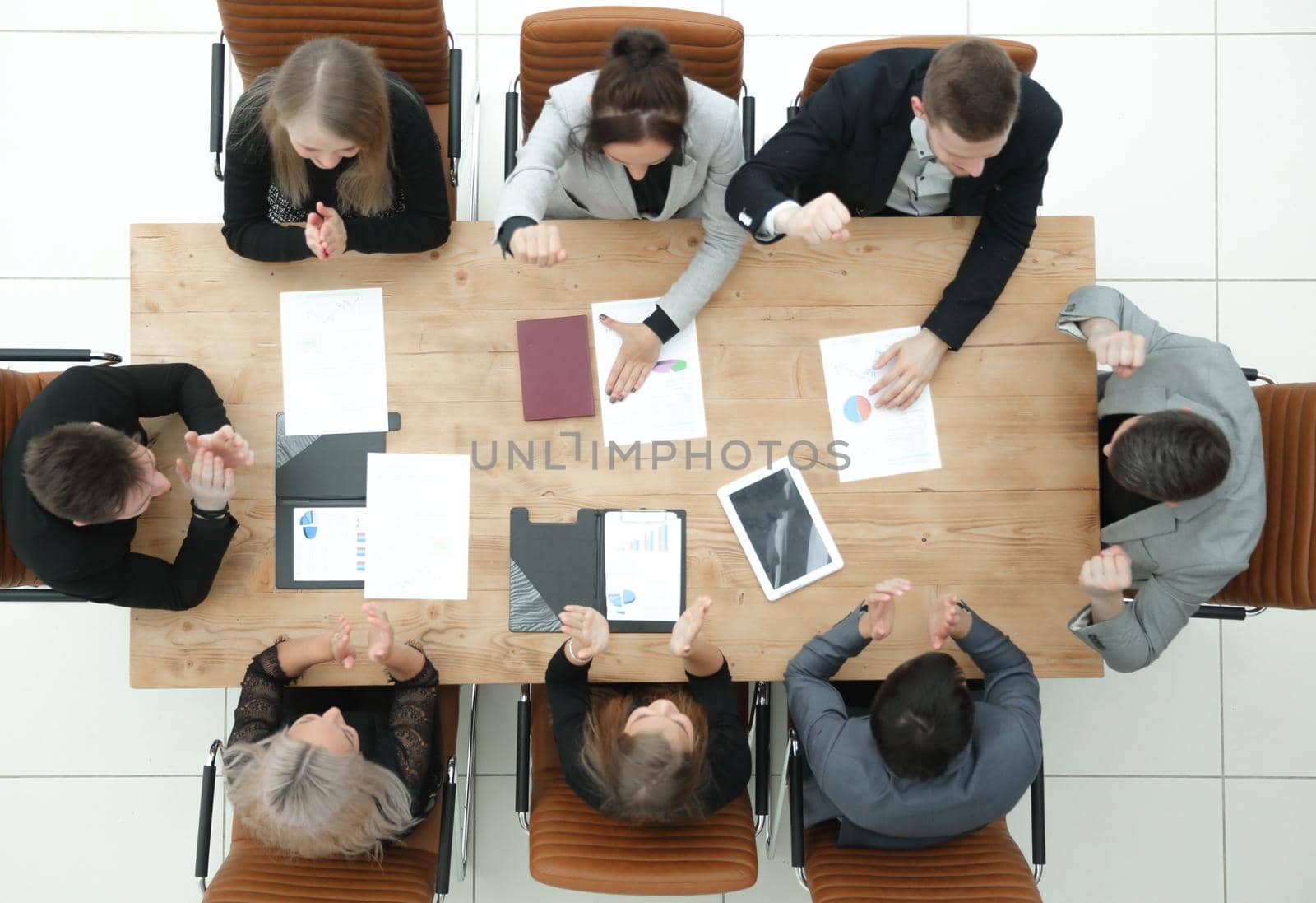 top view. young business team sitting at a table and looking at the camera. business concept