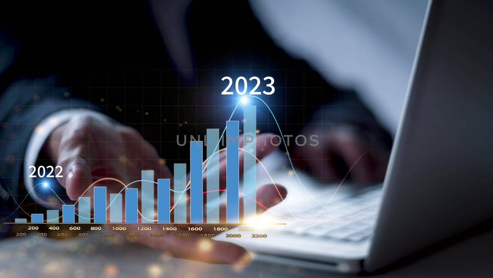 Businessman show golden stock market bar chart grow up to target. Business finance concept. Businessman's hands Show success graph, stocks grow every year and set goals for 2023