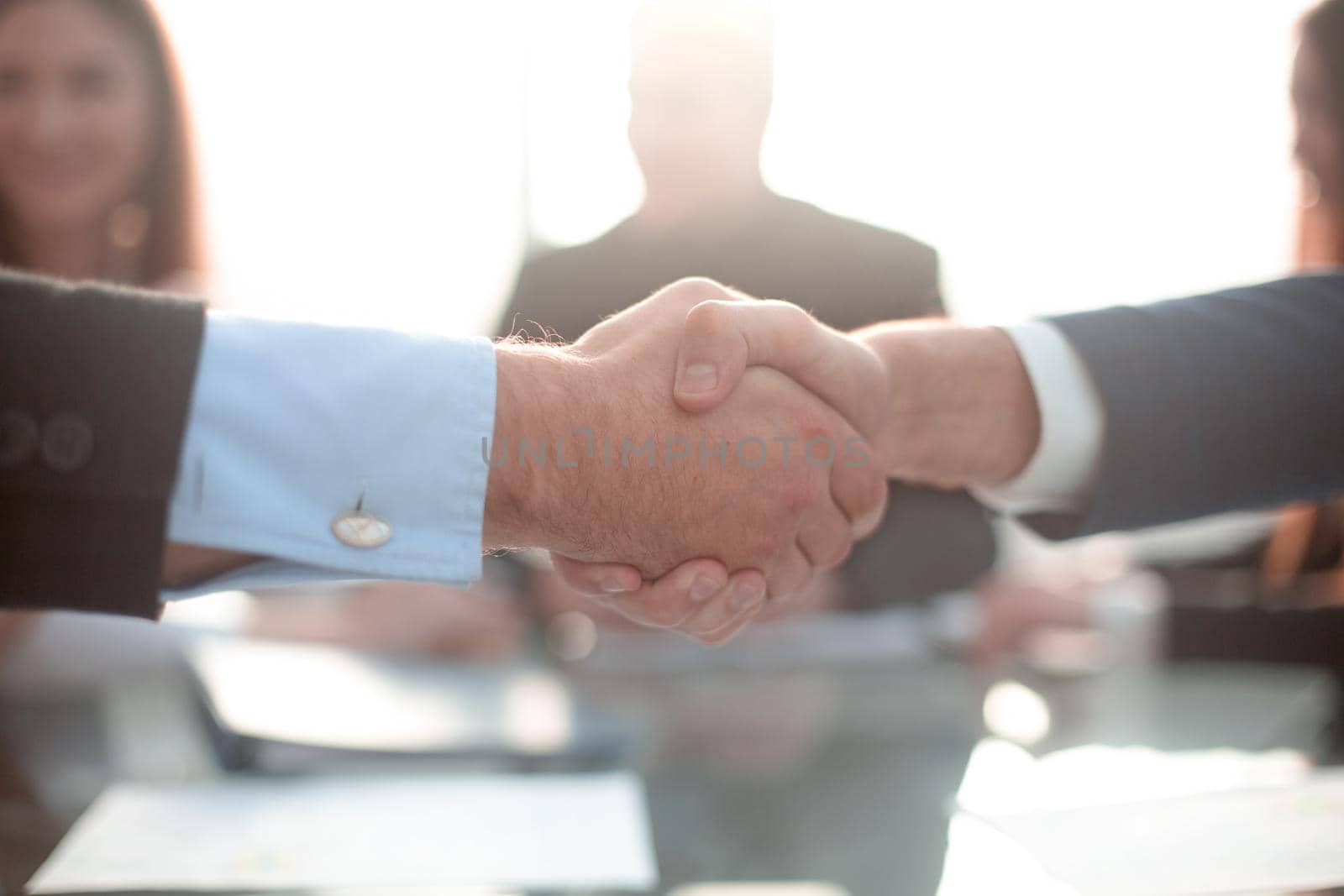 Businessmen shaking hands during a meeting by asdf