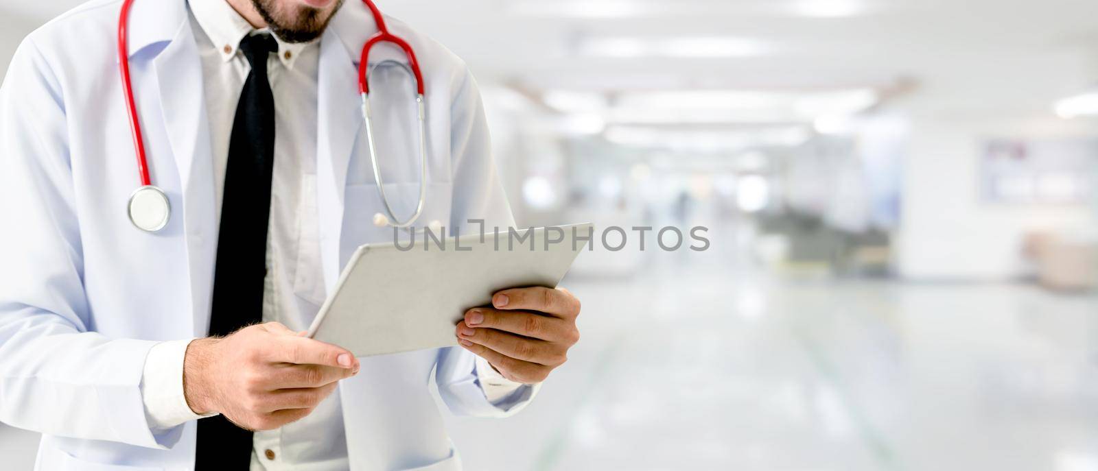 Doctor using tablet computer at the hospital. by biancoblue