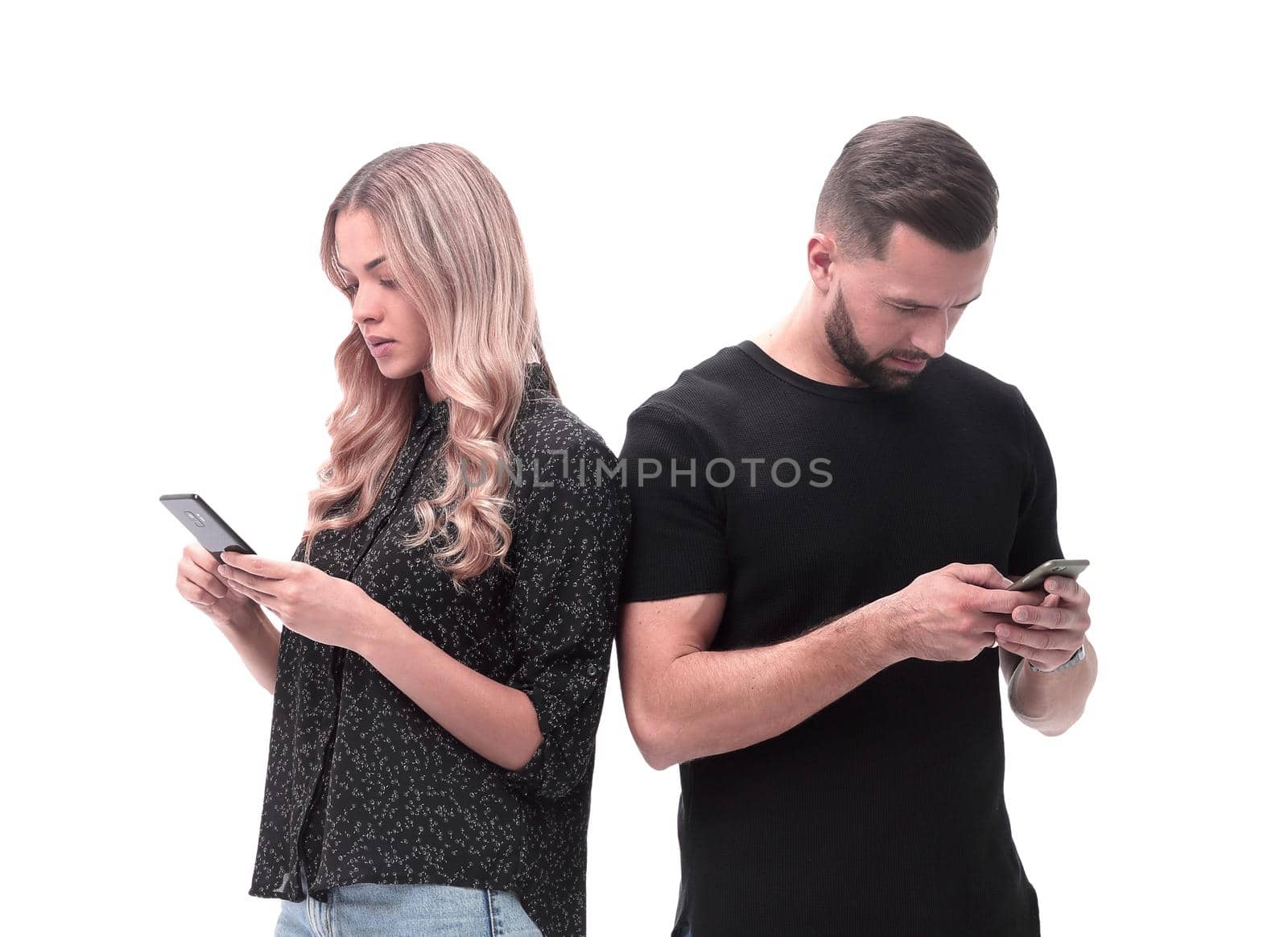 loving young couple reading e-mails on their smartphone by asdf