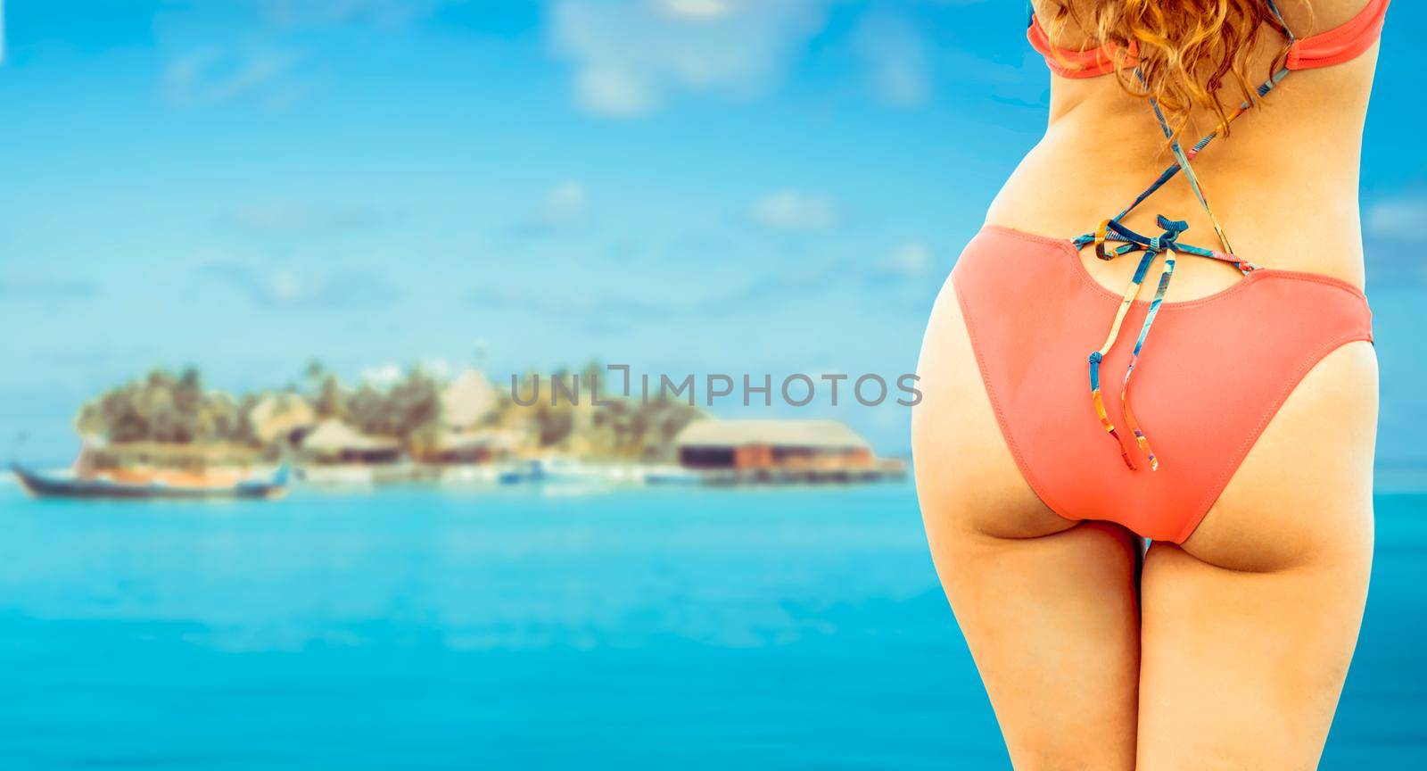 Happy young woman wearing swimsuit at tropical sand beach resort in summer for holiday travel vacation.