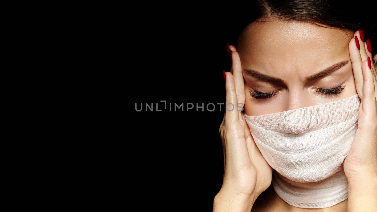 Beautiful woman with bandage mask on face. Fashion eye make-up. Beauty surgery or protection hygiene in covid19 pandemic by MarinaFrost