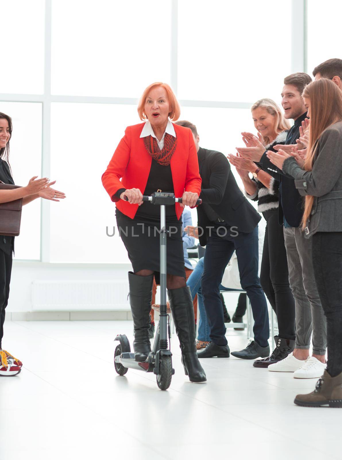 business woman on a scooter in the office in her free time by asdf