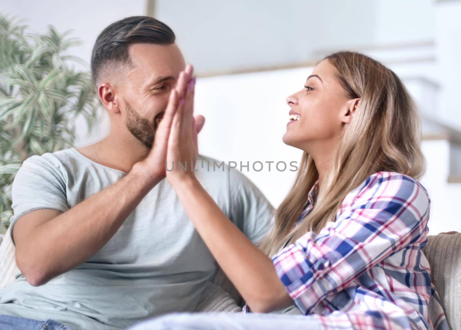 young couple giving each other a high five by asdf