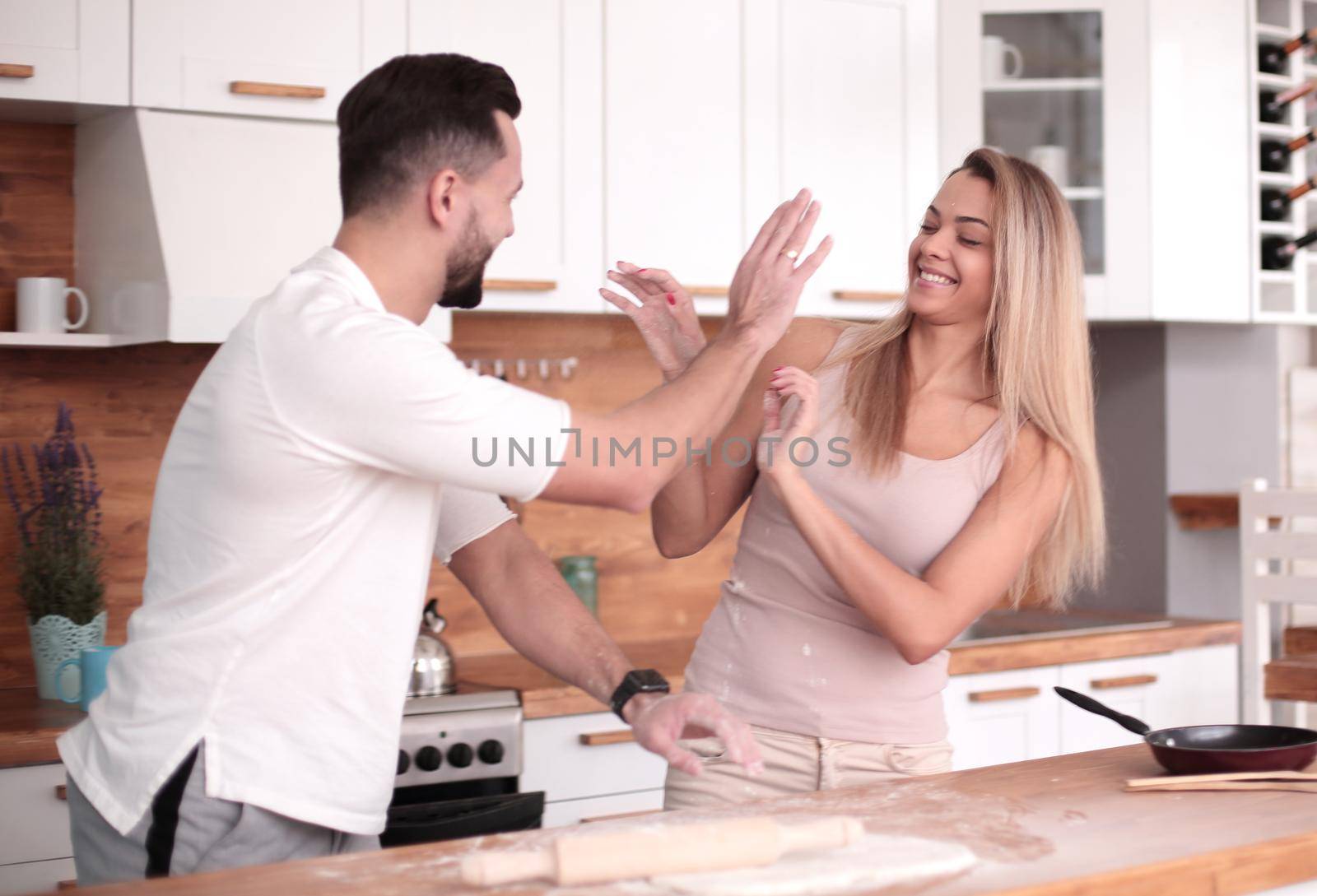 young couple communicates in the home kitchen by asdf