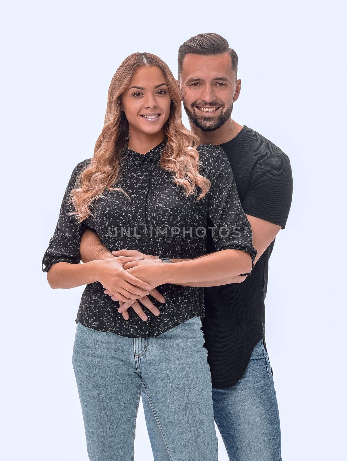 in full growth. young couple in love standing together . isolated on white background