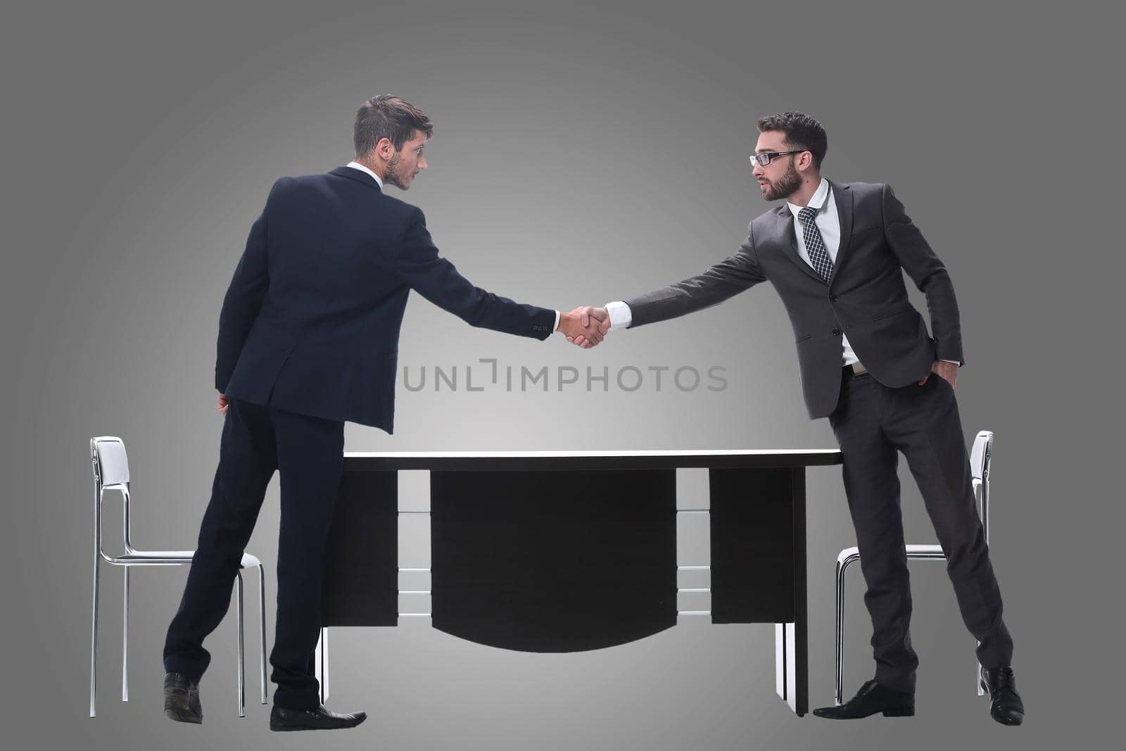 two business people shaking hands . isolated on white by asdf