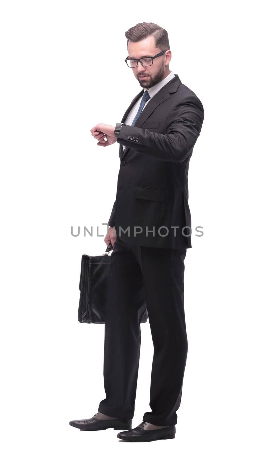 full length . Executive businessman looking at his wristwatch. isolated on white background