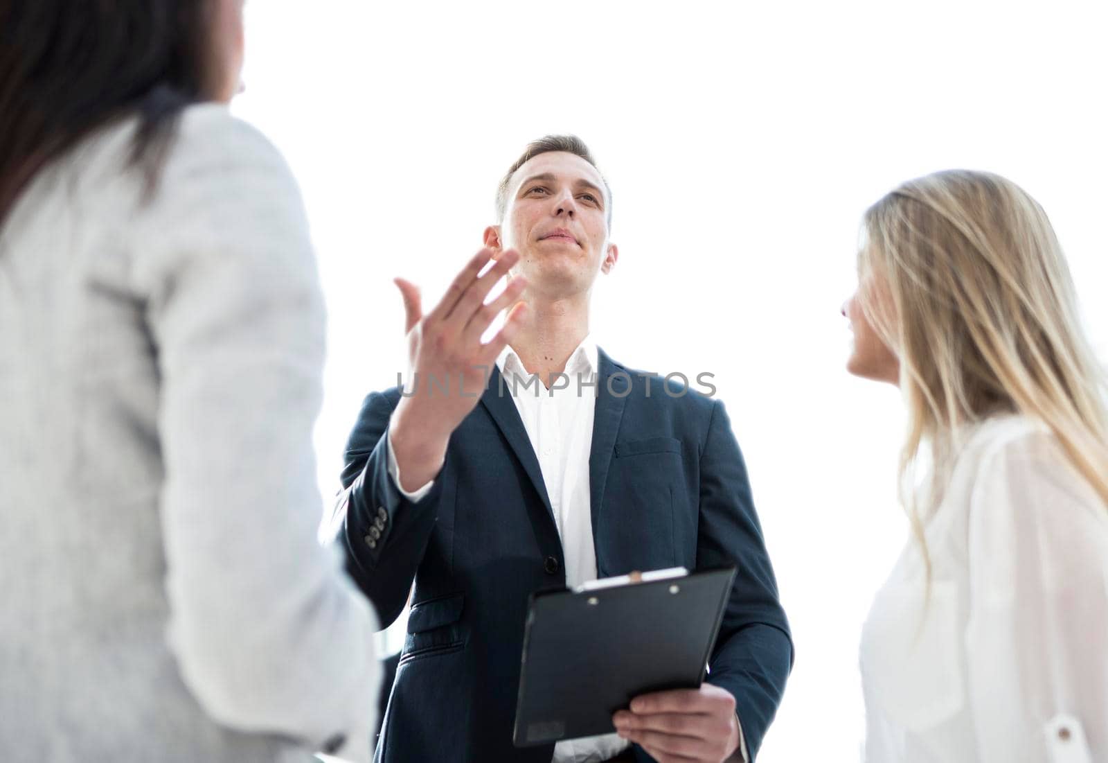 close up. employee explaining his ideas to colleagues . office workdays