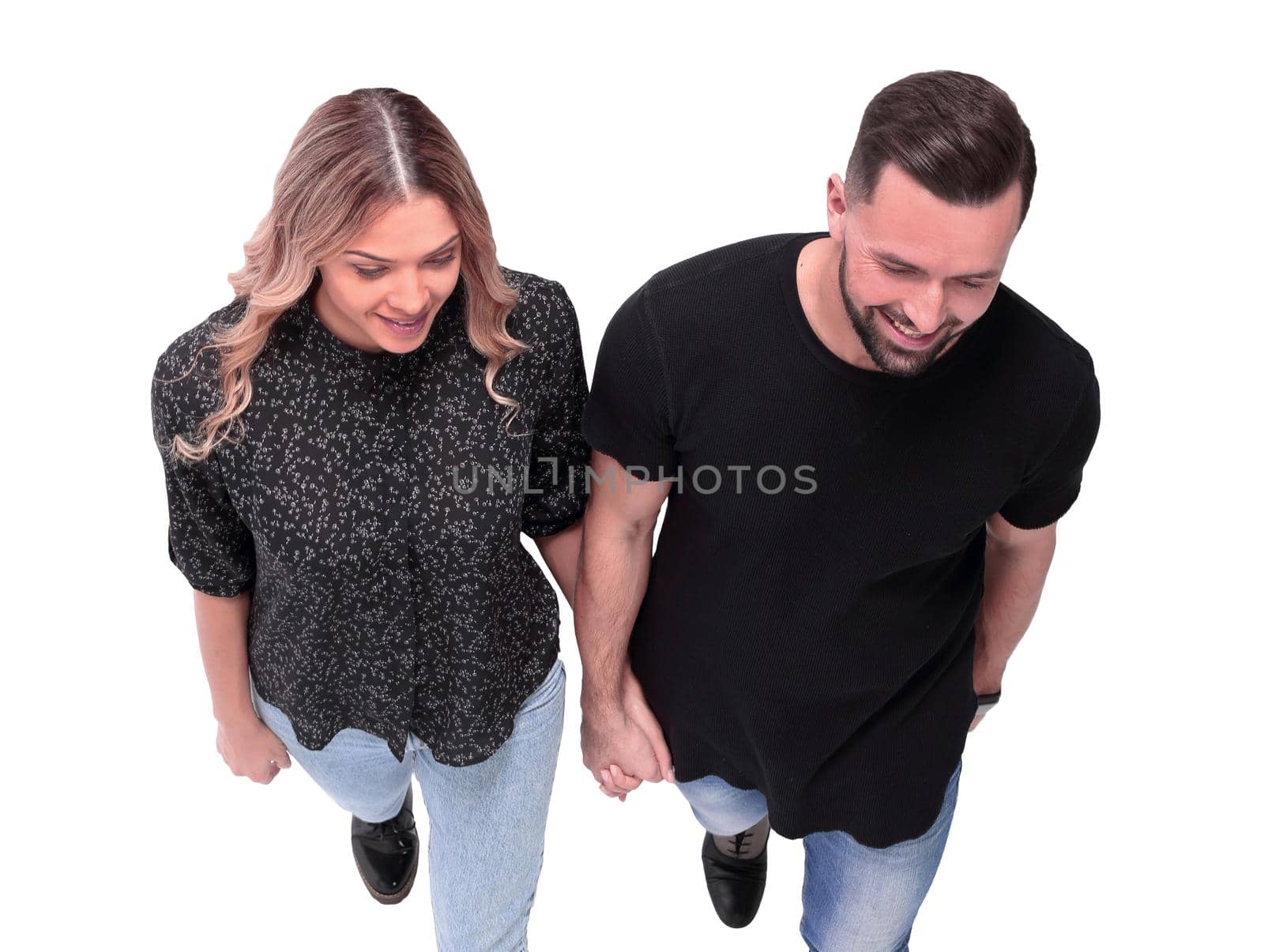 top view. stylish young couple walking together . isolated on white background