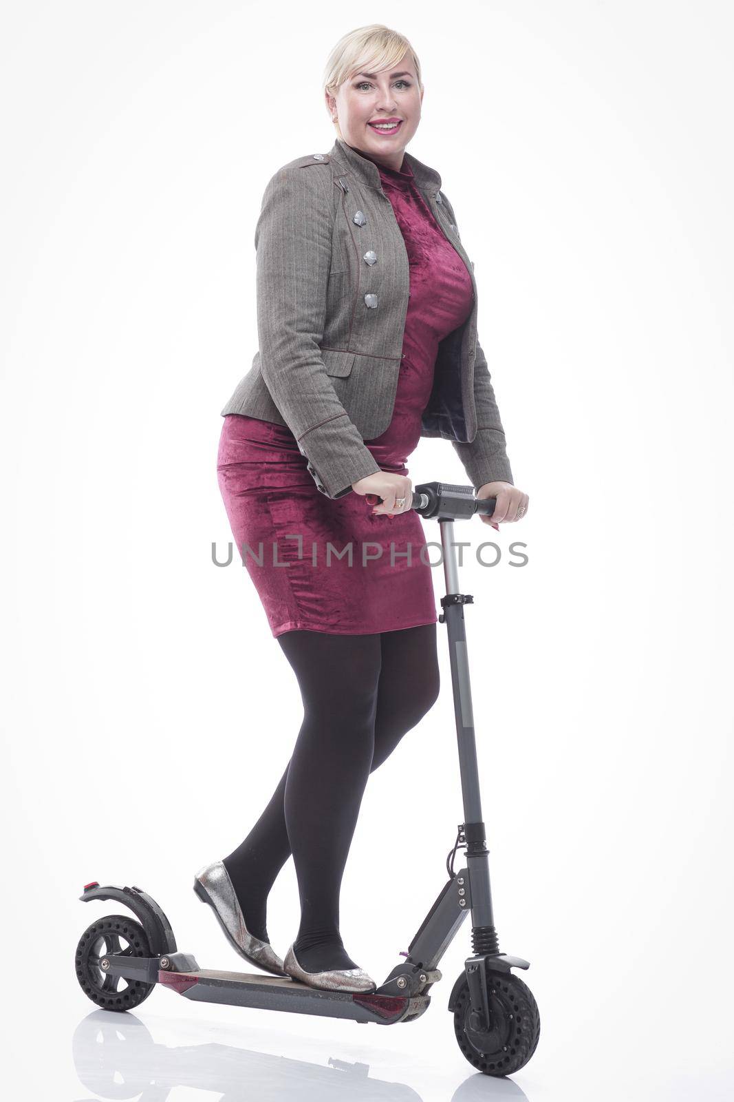 in full growth. modern young woman with an electric scooter. isolated on a white background.