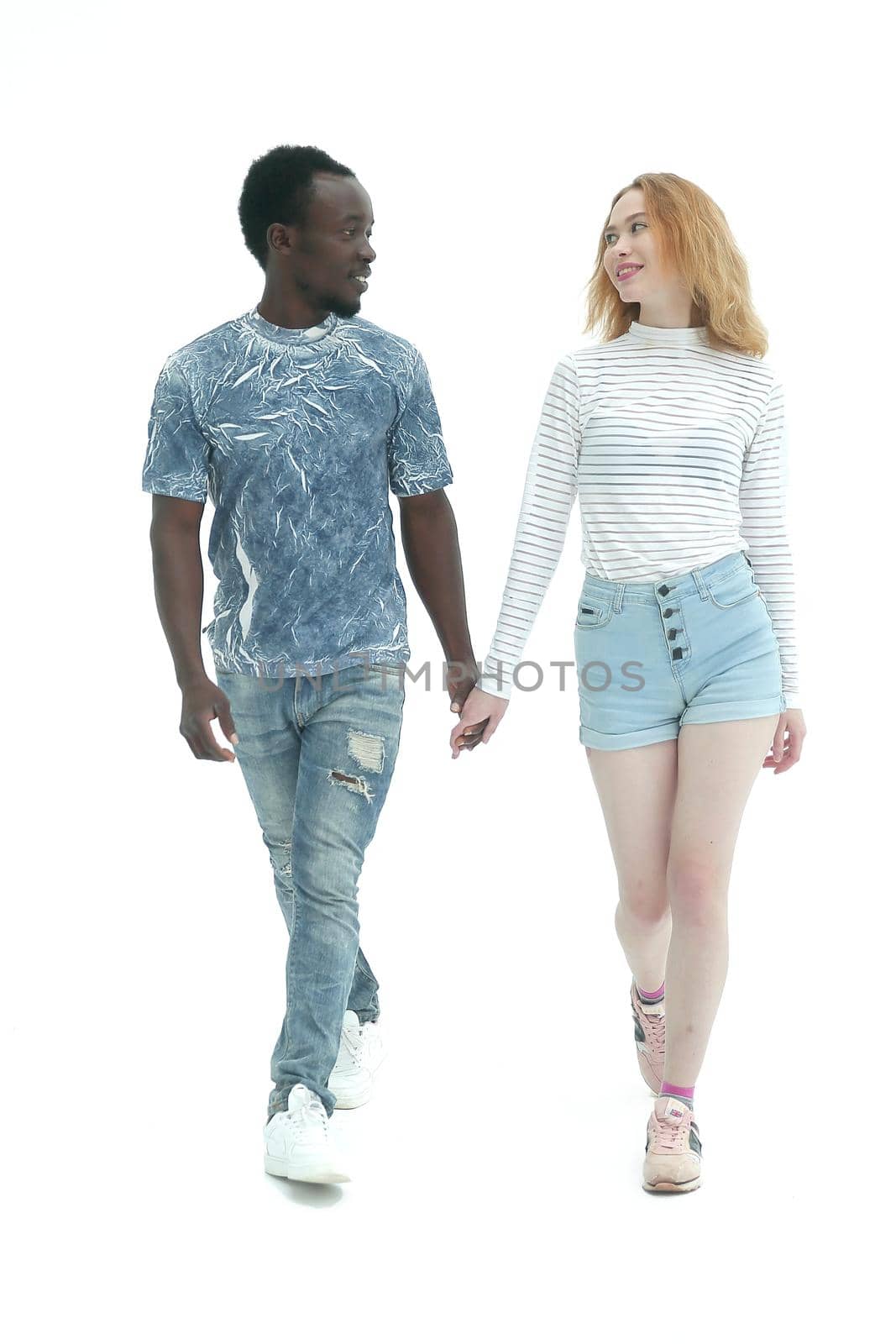 in full growth. casual guy and girl stepping forward. isolated on white