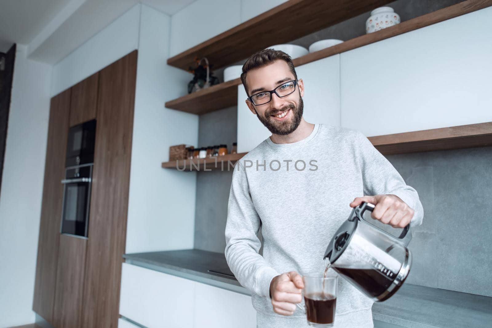close up. a man pouring himself a Cup of morning coffee. photo with copy space