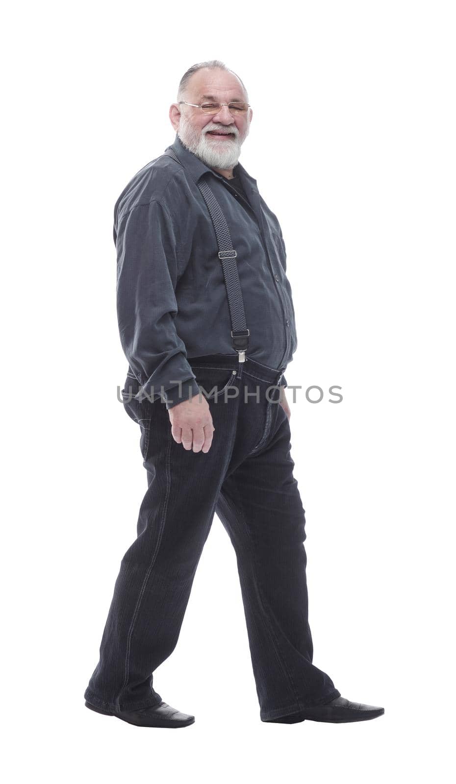 in full growth. happy bearded man striding forward. isolated on a white background