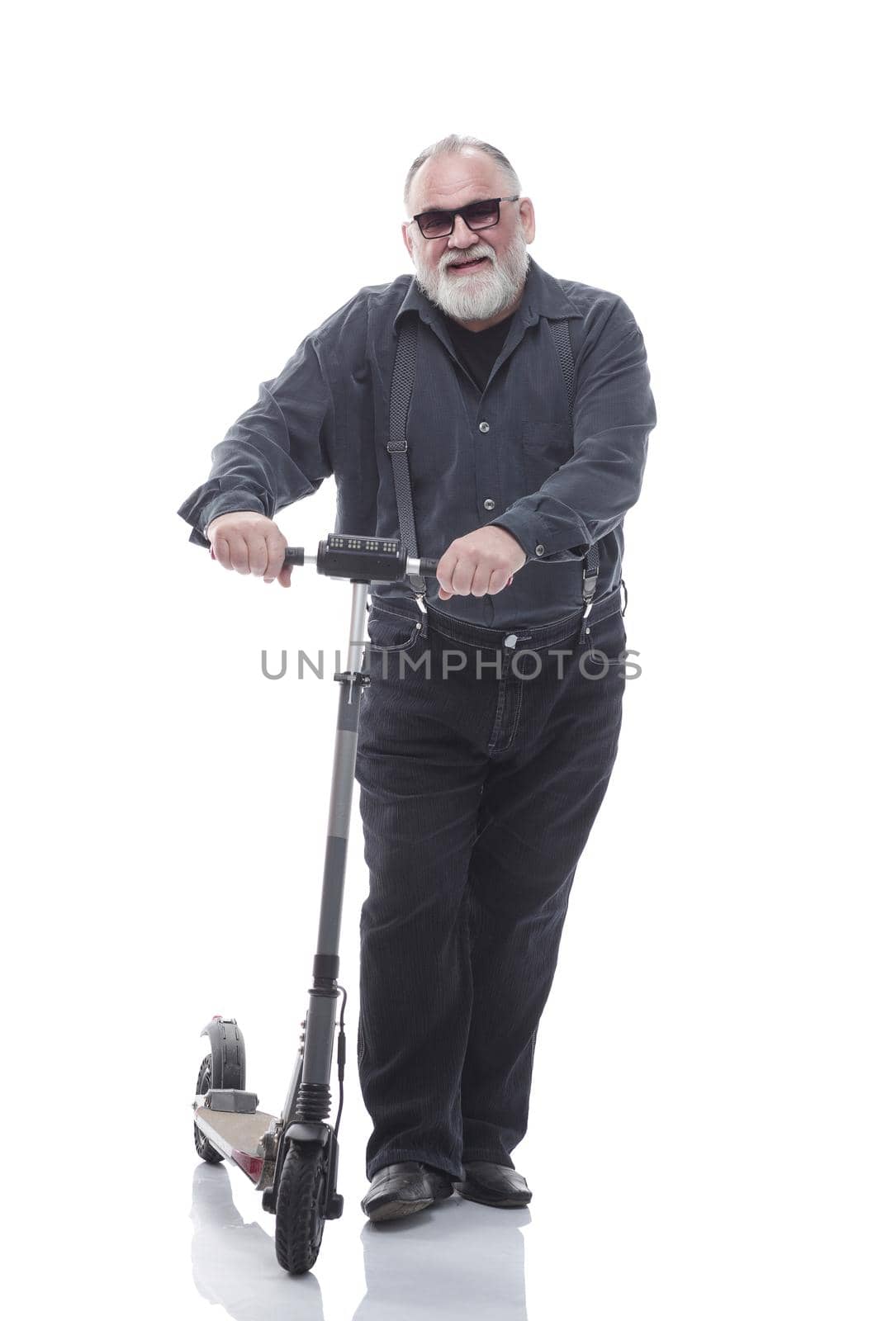 in full growth. elderly man standing on electric scooter. isolated on a white background