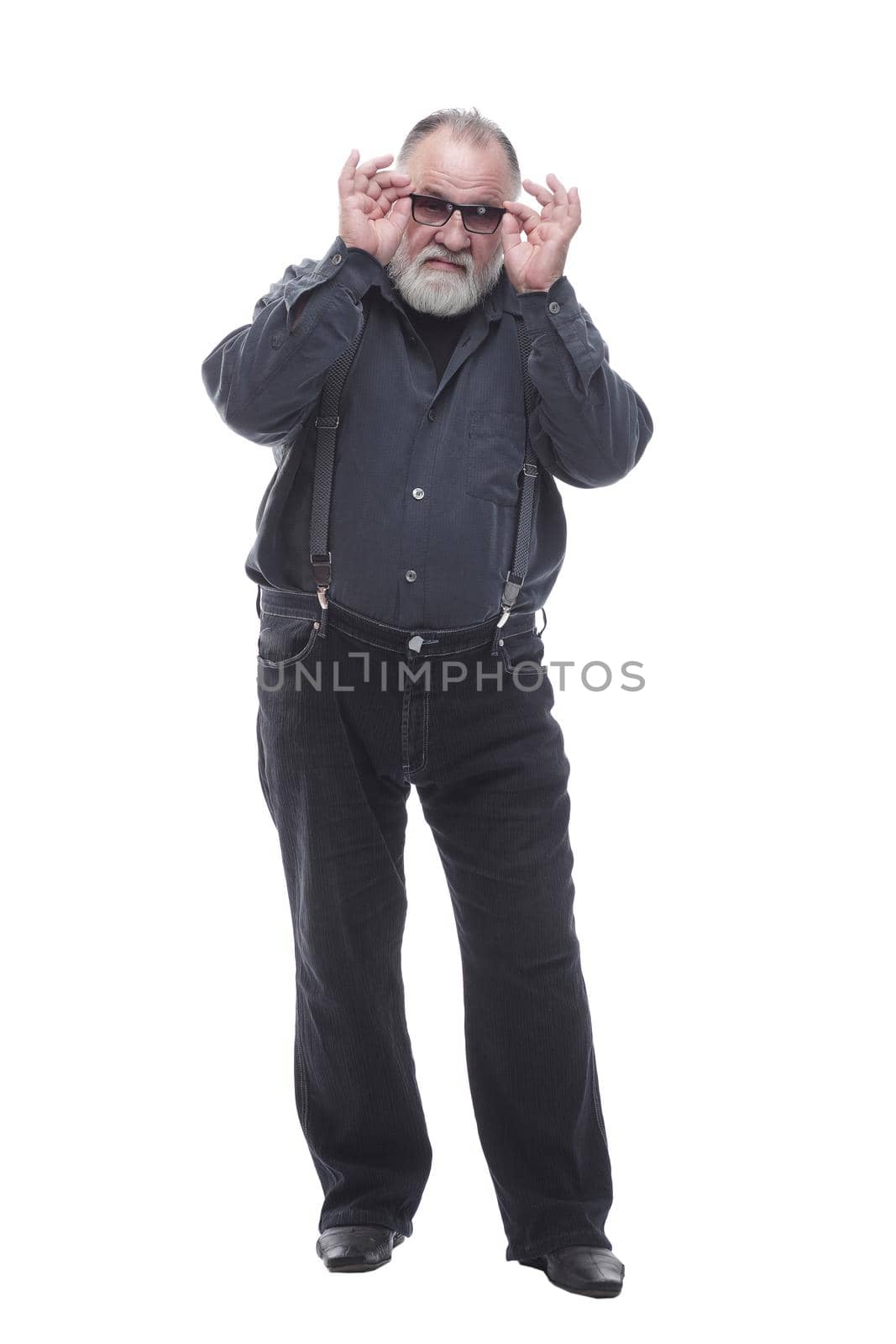 serious elderly man looking through glasses. isolated on a white by asdf