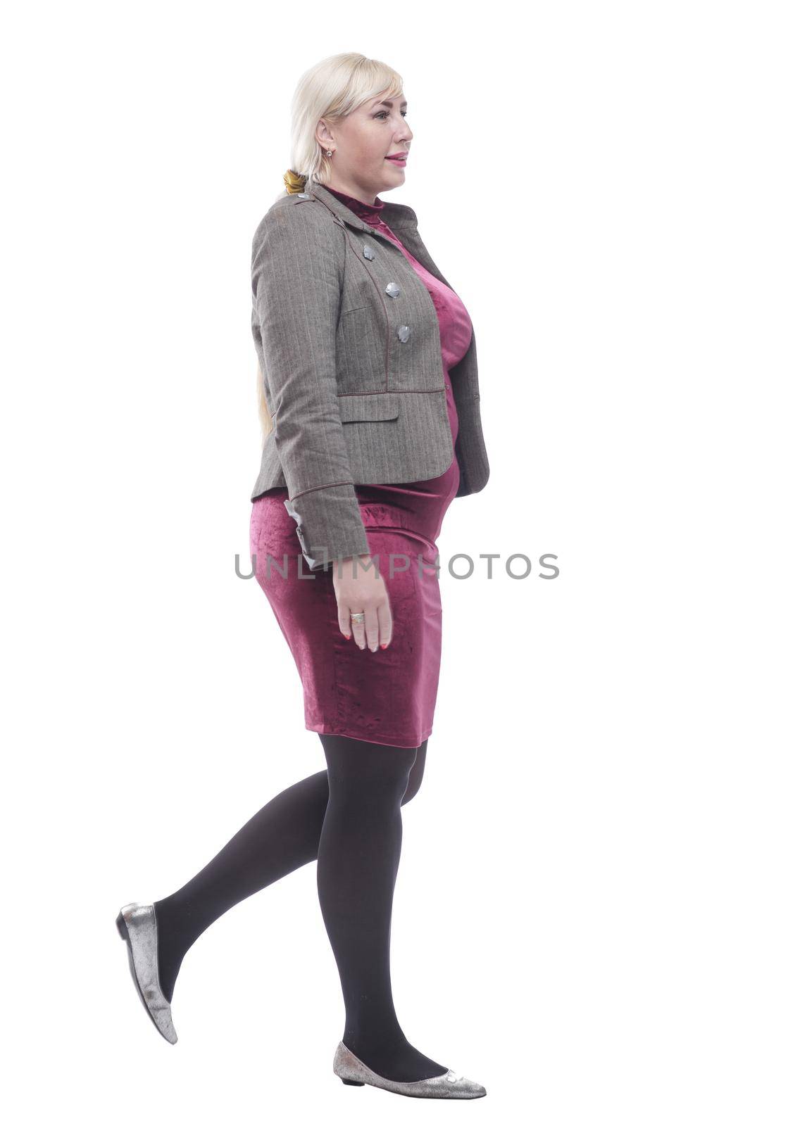 side view . casual young woman stepping forward . isolated on a white background.