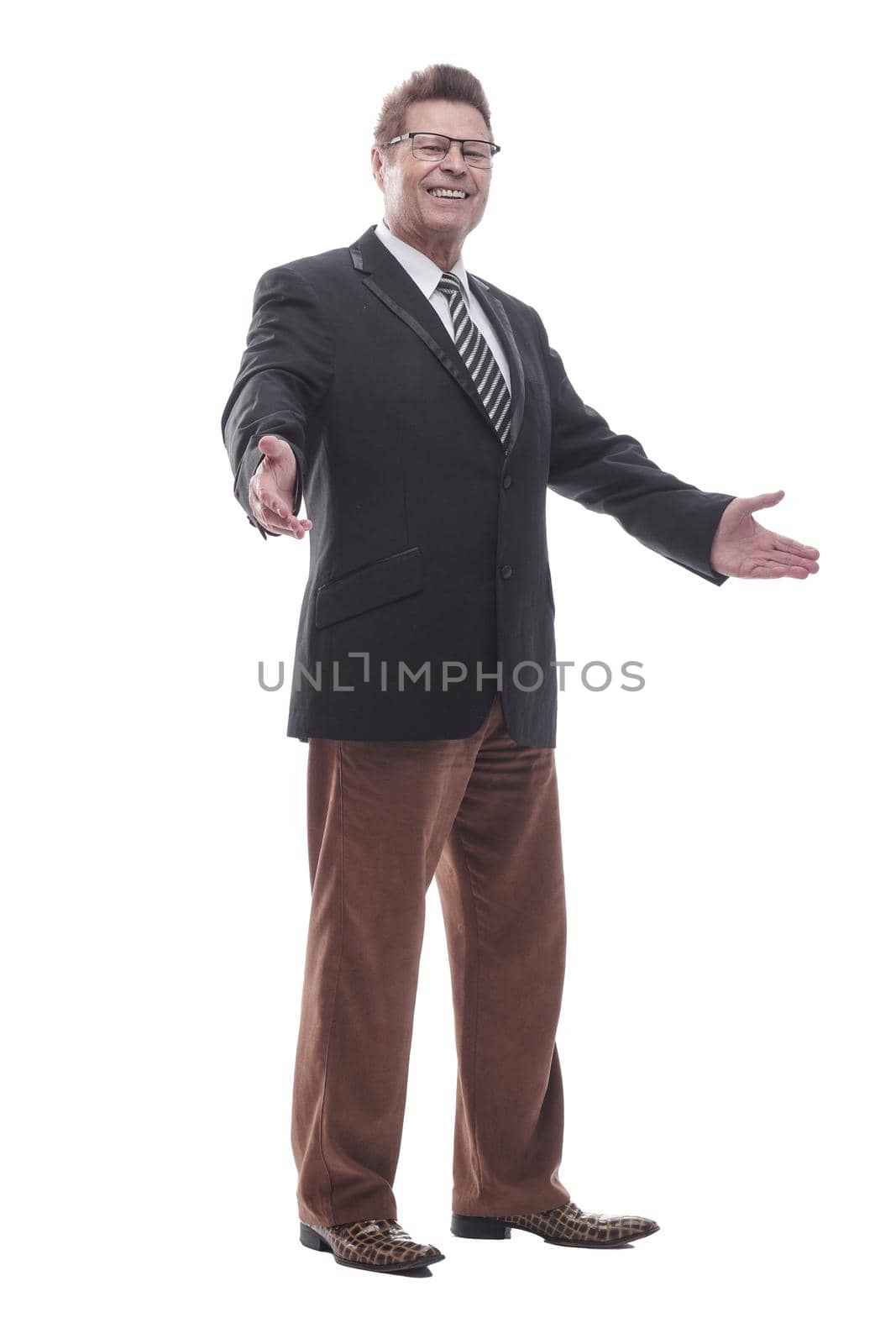 side view. friendly business man looking at the camera . isolated on a white background