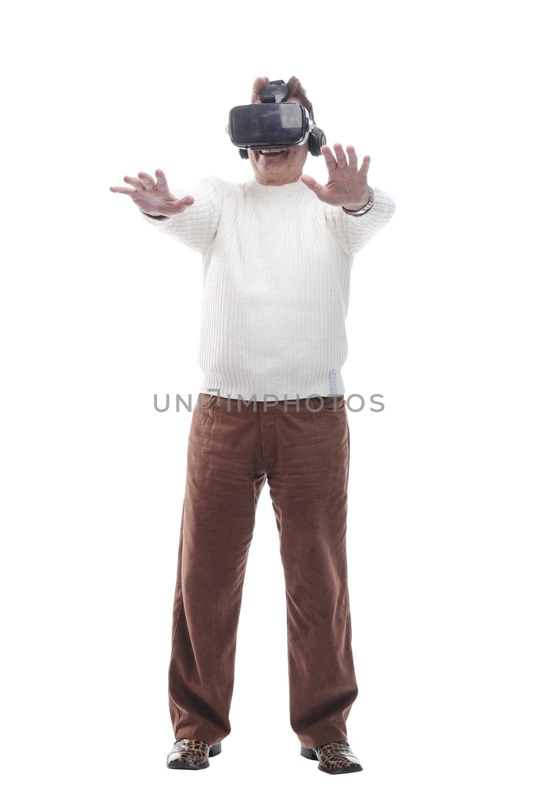 in full growth. adult male looking with interest through virtual reality glasses. isolated on a white