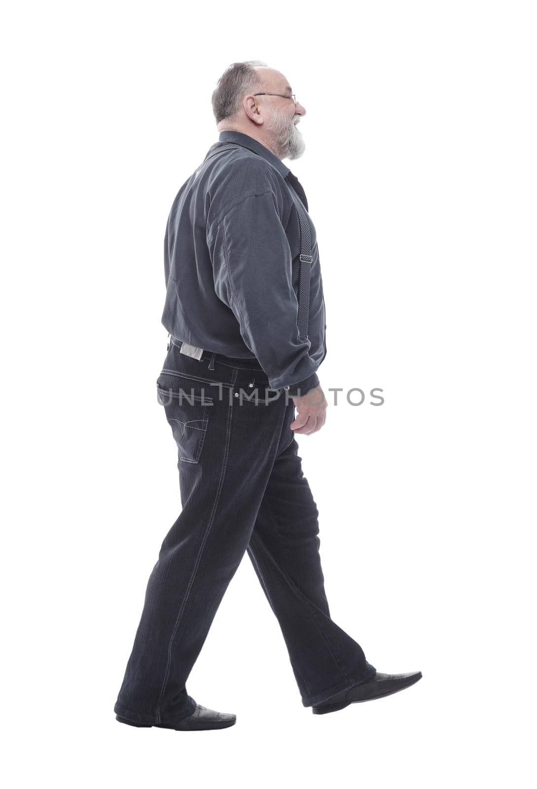 in full growth. happy bearded man striding forward. isolated on a white background