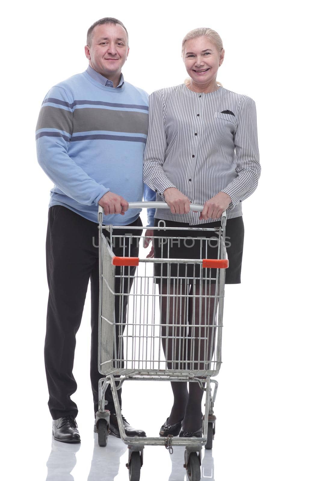 in full growth. casual couple with shopping cart . isolated on a white background