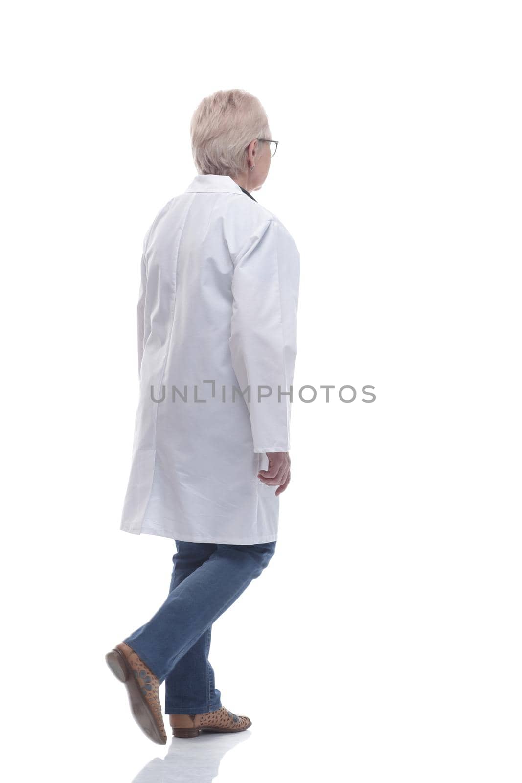 in full growth. e xperienced f emale d octor w alking t owards you . isolated on a white background