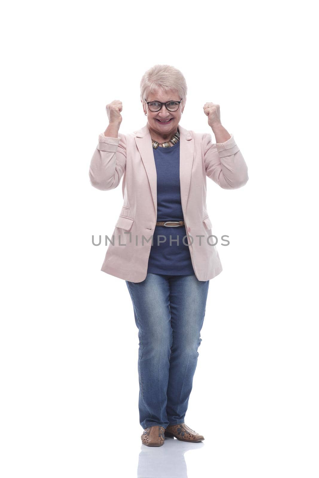 in full growth. friendly old lady looking at the camera . isolated on a white background