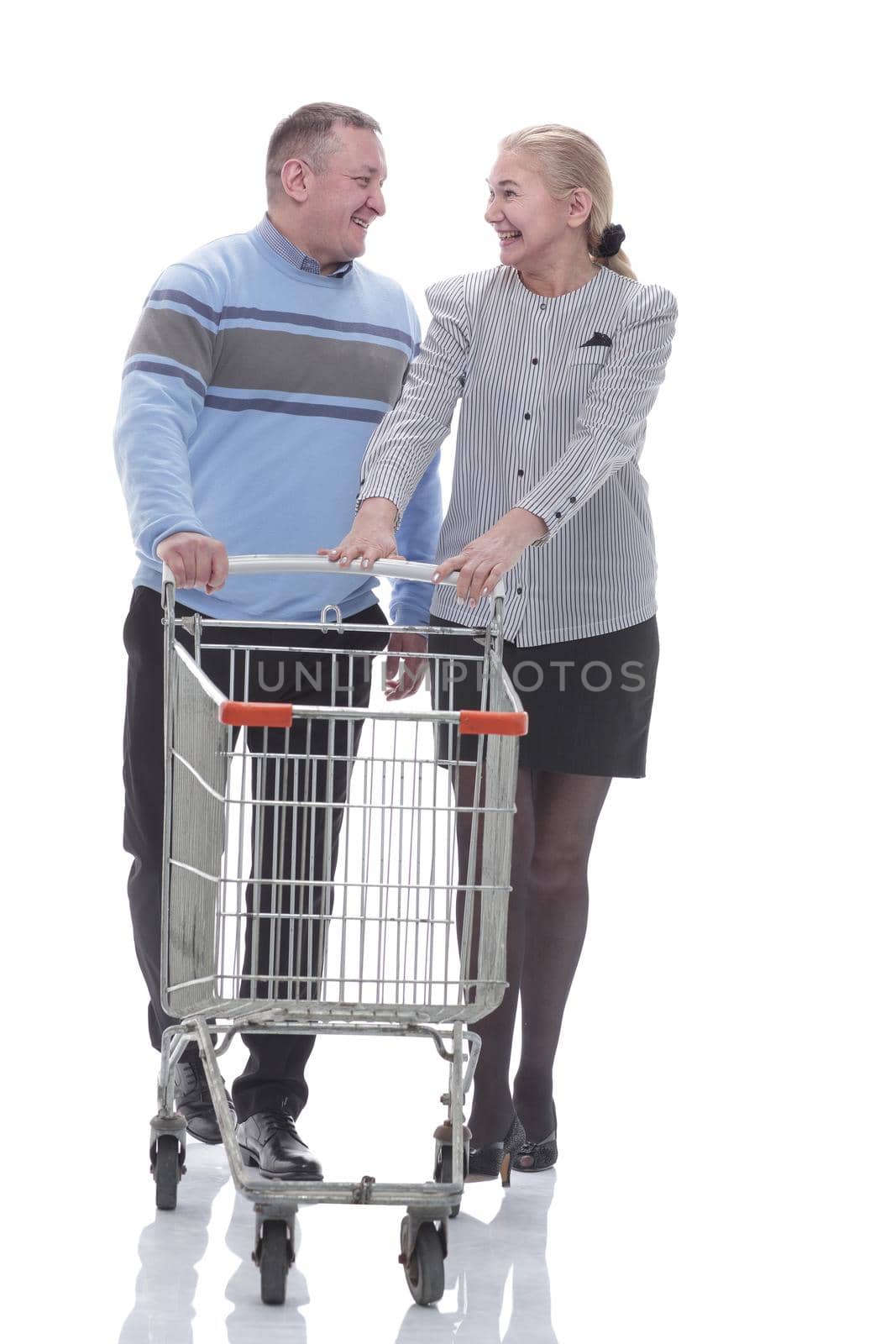 in full growth. casual couple with shopping cart by asdf