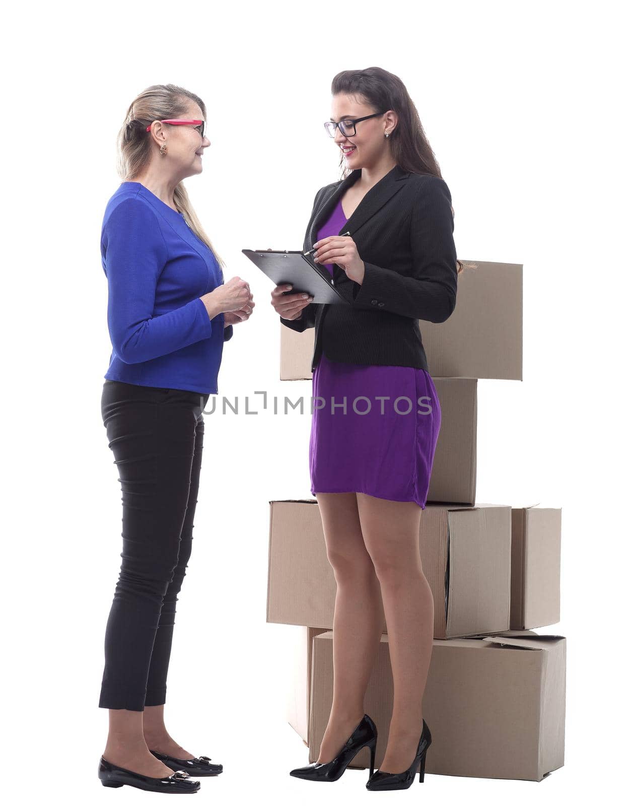 in full growth. courier and the customer standing next to cardboard boxes. isolated on a white background