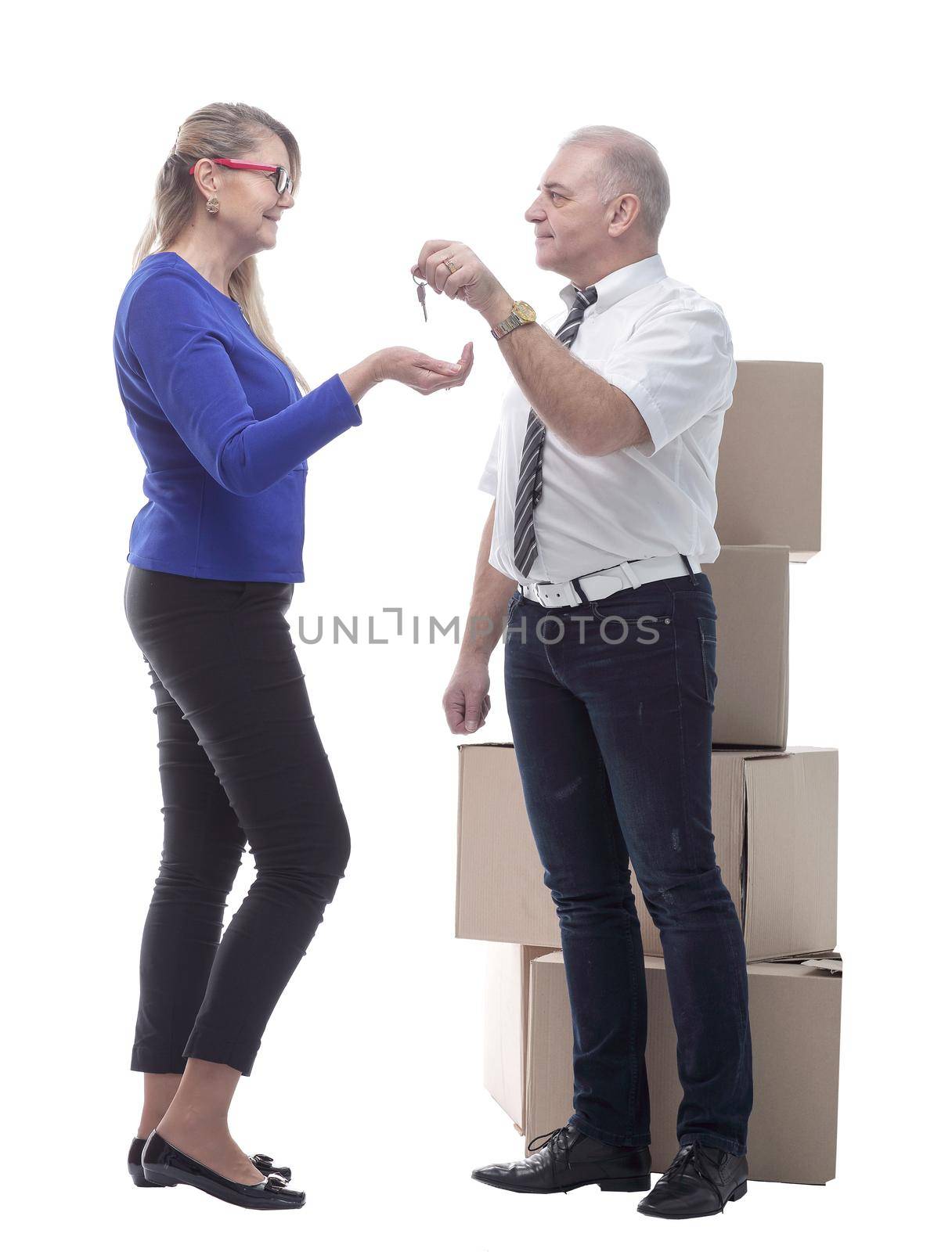 in full growth. real estate agent handing keys to a happy buyer . isolated on a white background
