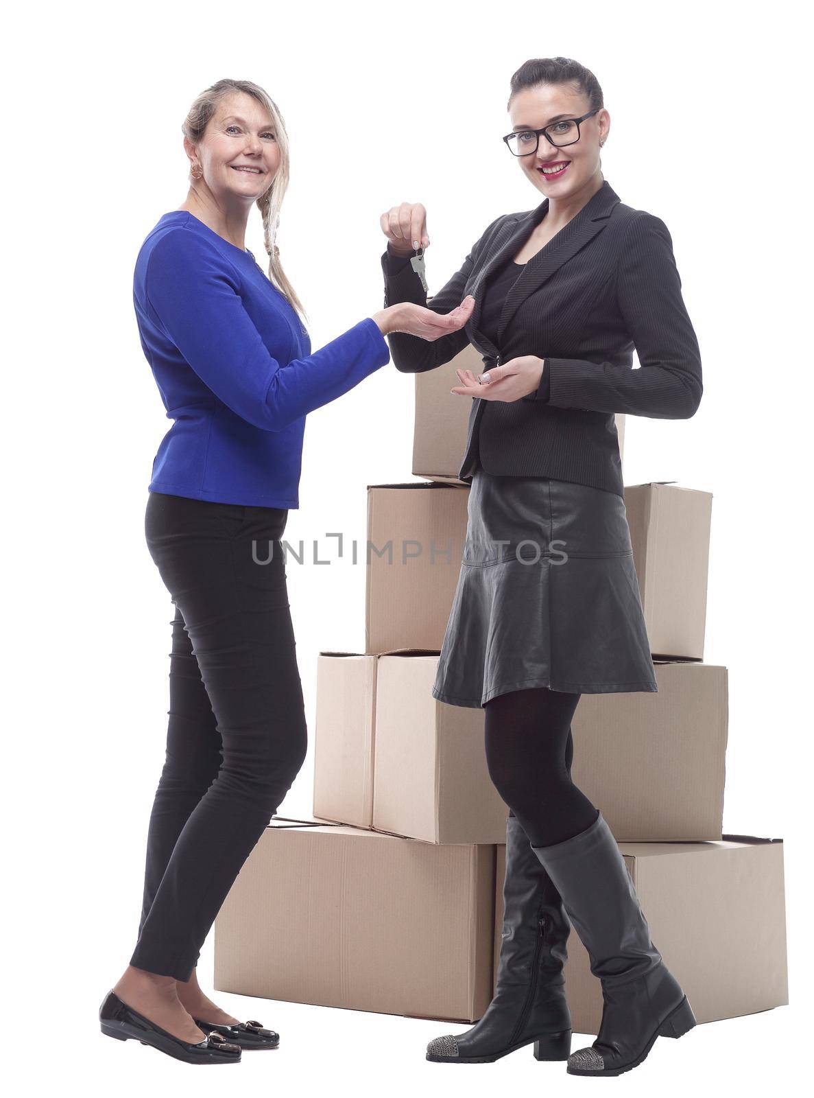 in full growth. real estate agent handing keys to a happy woman . isolated on a white background