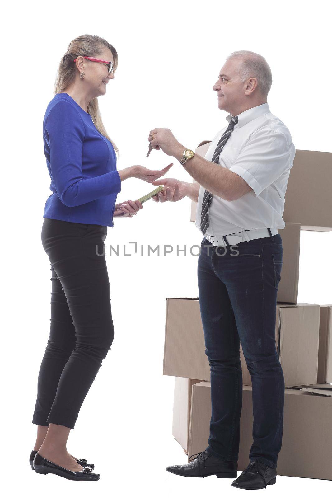 in full growth. real estate agent handing keys to a happy buyer . isolated on a white background