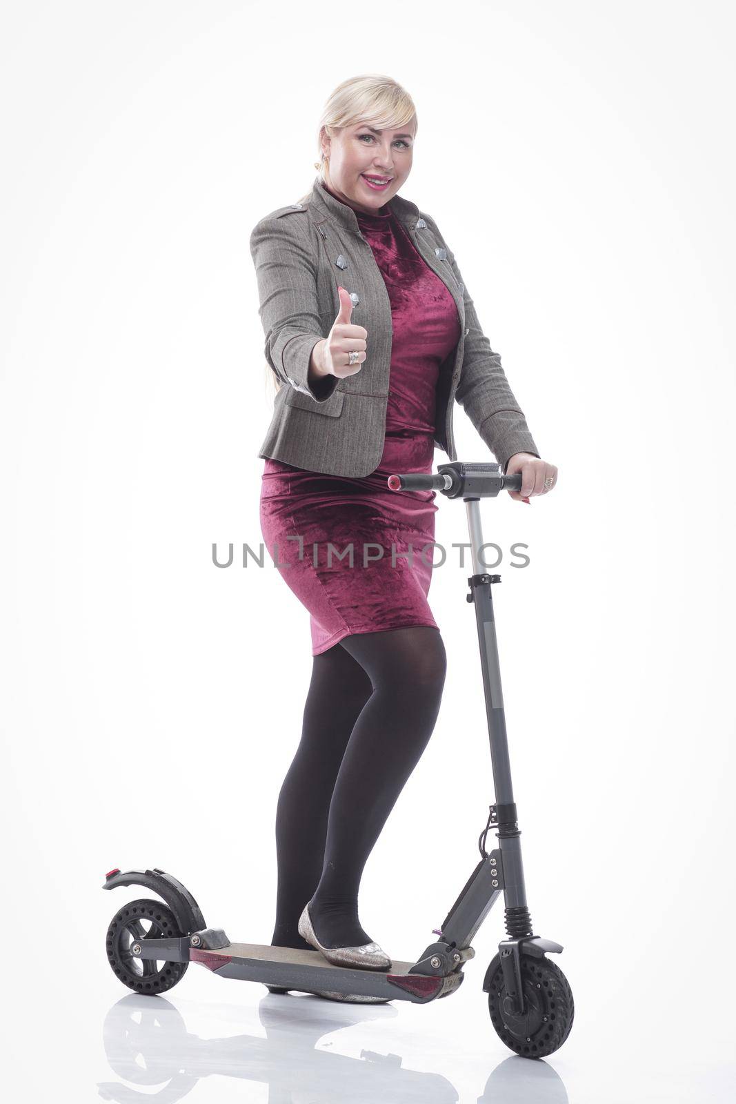 in full growth. attractive happy woman with an electric scooter. isolated on a white background.