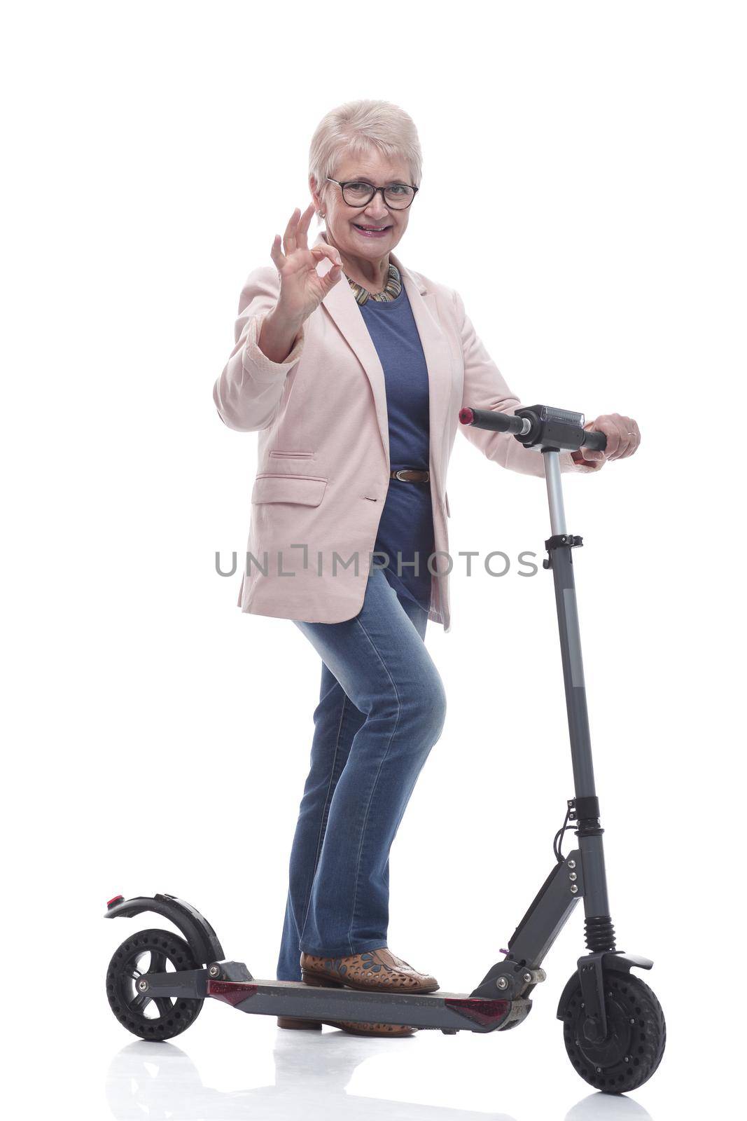 in full growth. happy adult woman with electric scooter. by asdf