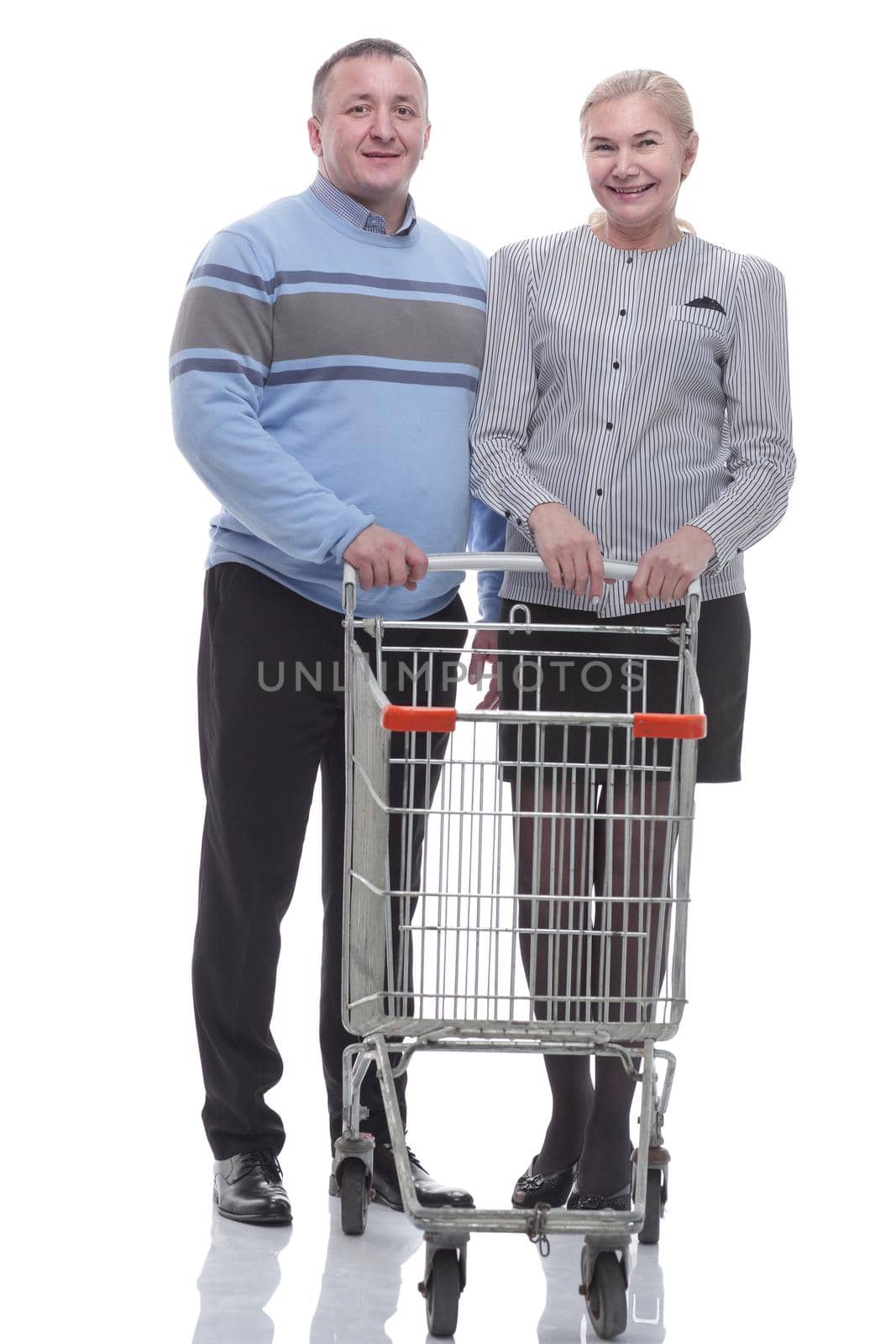 in full growth. casual couple with shopping cart . isolated on a white background