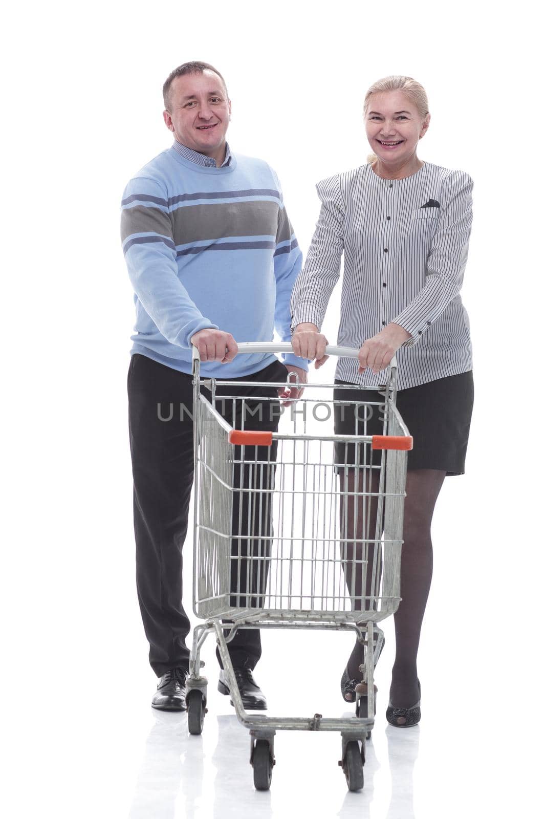 in full growth. casual couple with shopping cart by asdf