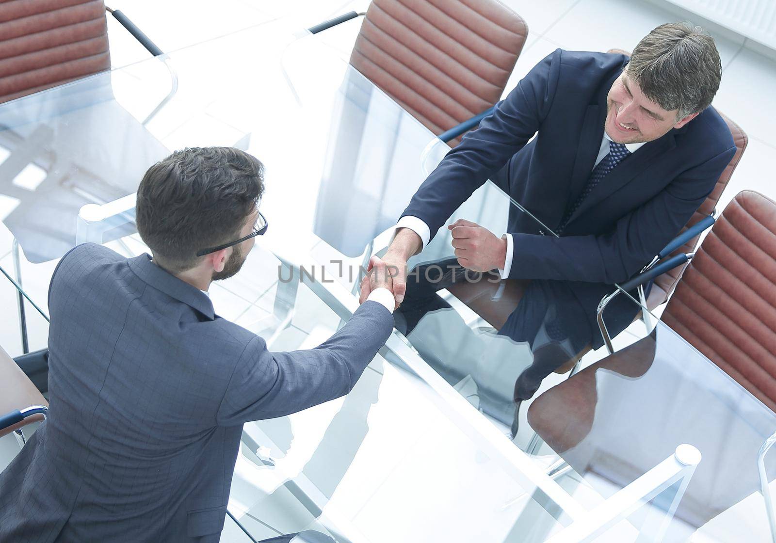 View from above . Handshake of financial partners after negotiations